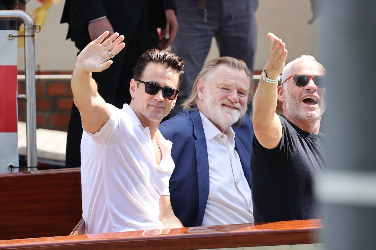 "The Banshees Of Inisherin" cast Colin Farrell, Brendan Gleeson, and director Martin McDonagh wave from their boat at the 79th Venice International Film Festival