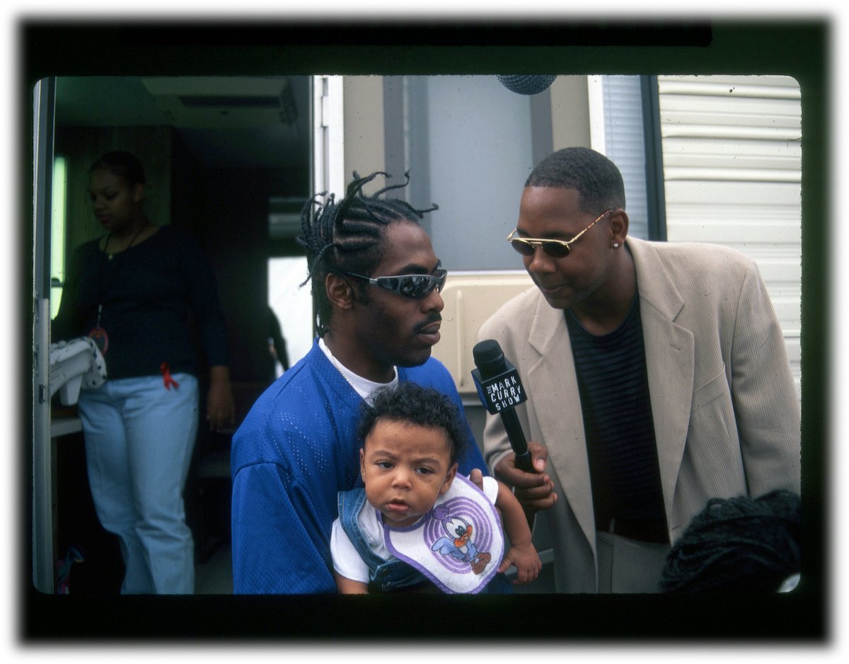 Coolio holds his son outside of his trailer in 1997