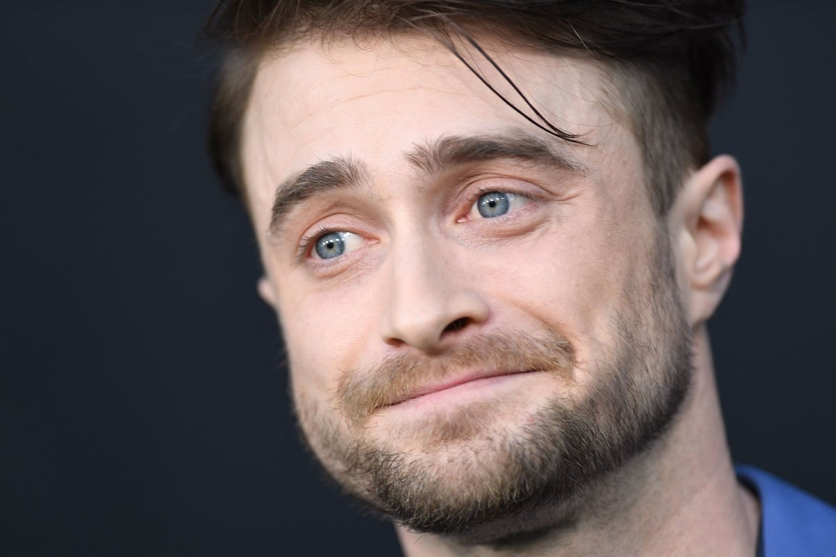 Daniel Radcliffe smiles for cameras at the premiere for 'The Lost City.