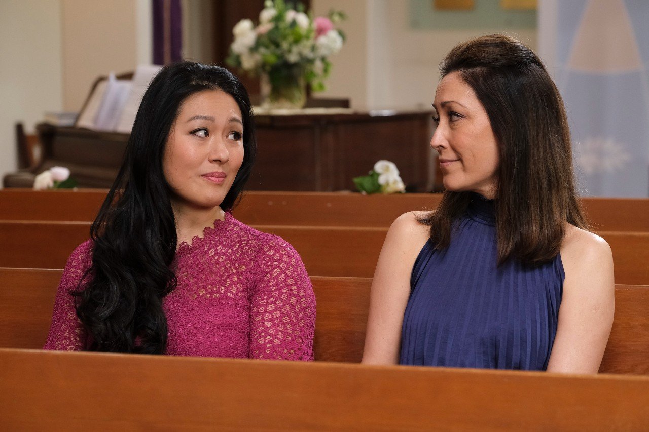 Nurse Villanueva and Dr. Audrey Lim sit in church and wait for Lea and Shaun to get married on 'The Good Doctor.'