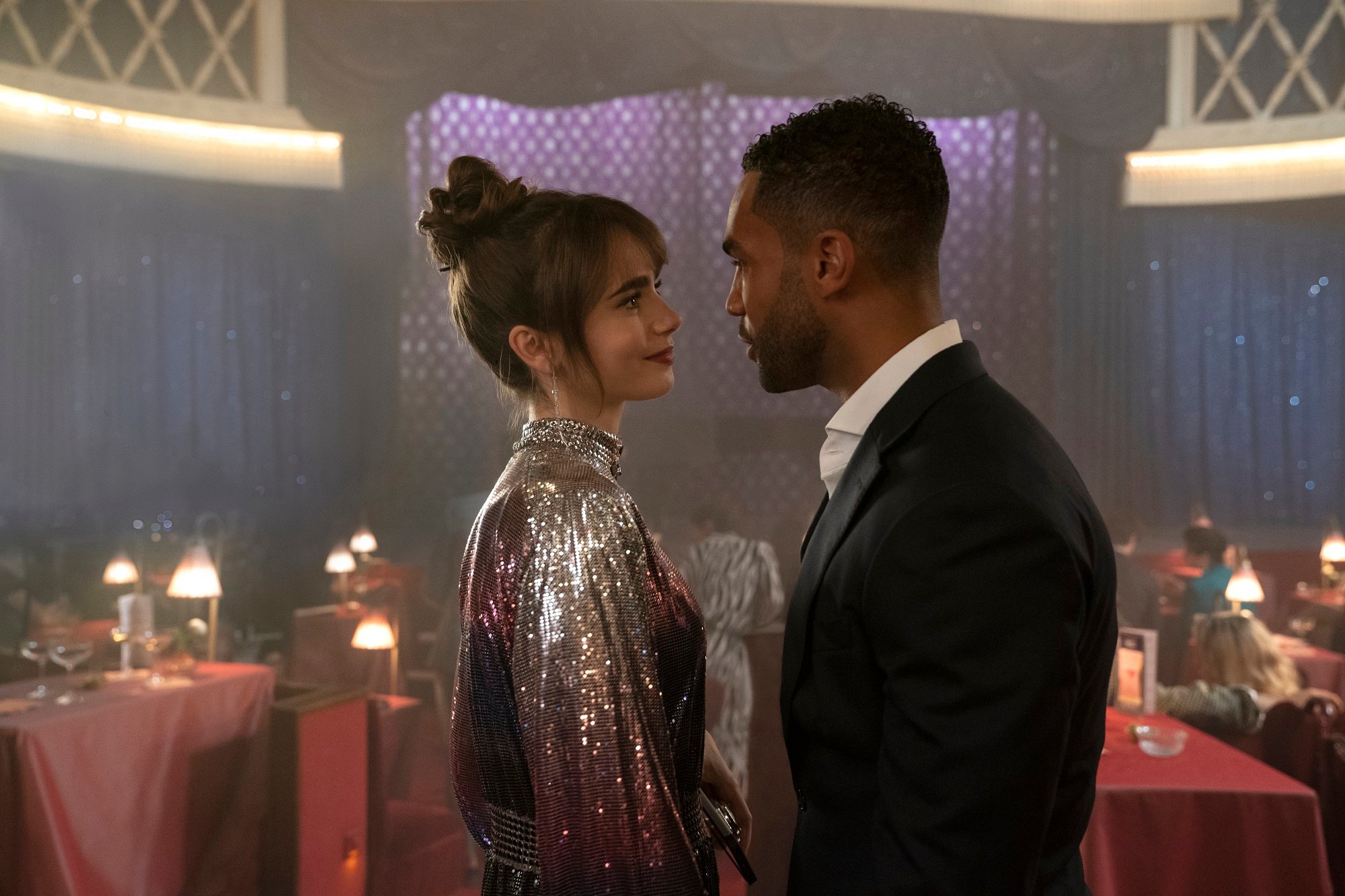 'Emily in Paris' Season 3: Lily Collins as Emily, and Lucien Laviscount as Alfie looking each other in the eyes