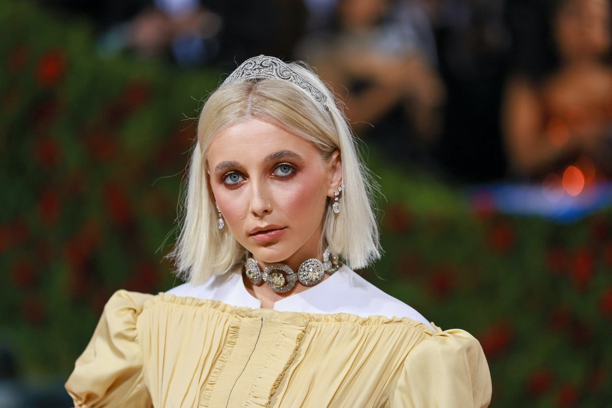 Emma Chamberlain in front of a blurred background