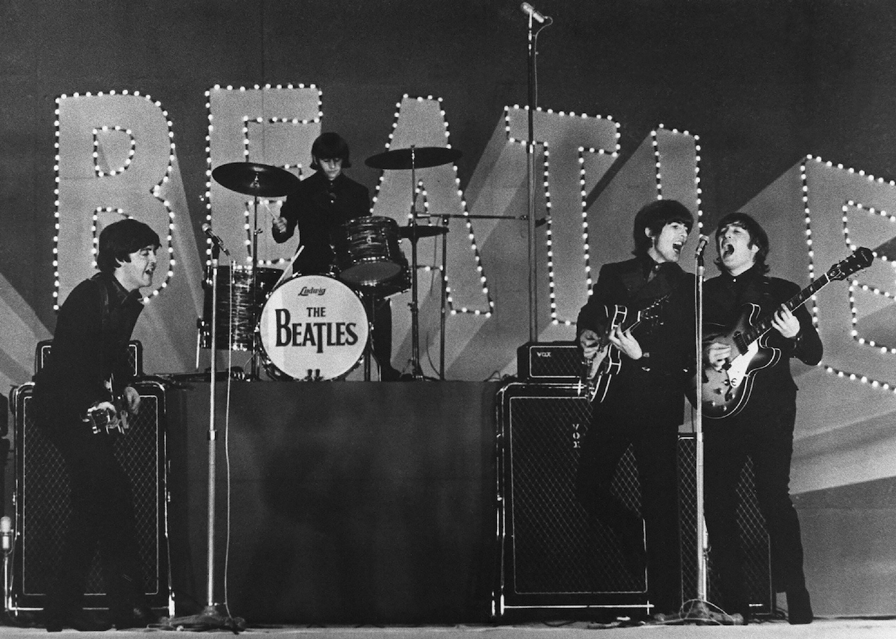 The Beatles performing in suits in Tokyo. 