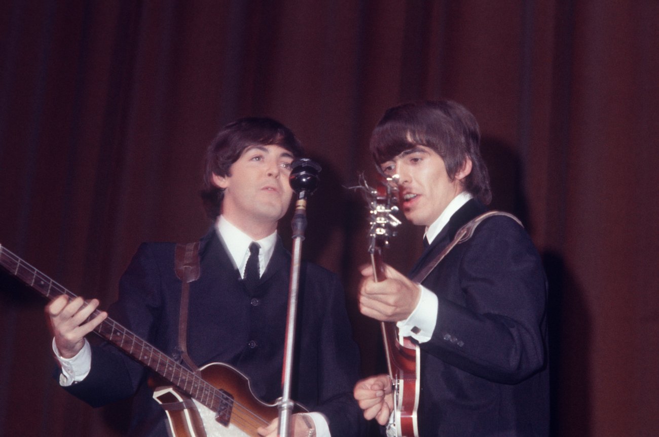 Paul McCartney and George Harrison performing with The Beatles in the early 1960s.