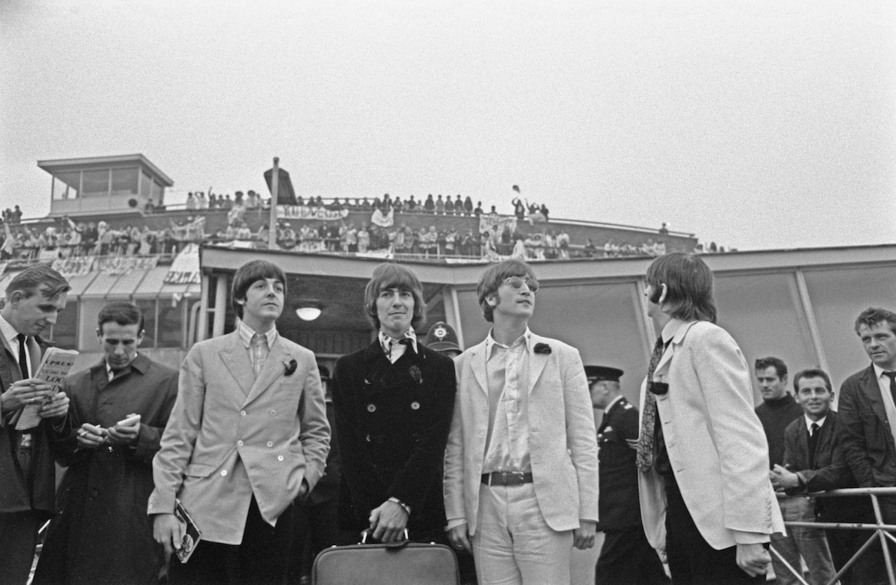 George Harrison and The Beatles at the airport in 1966.