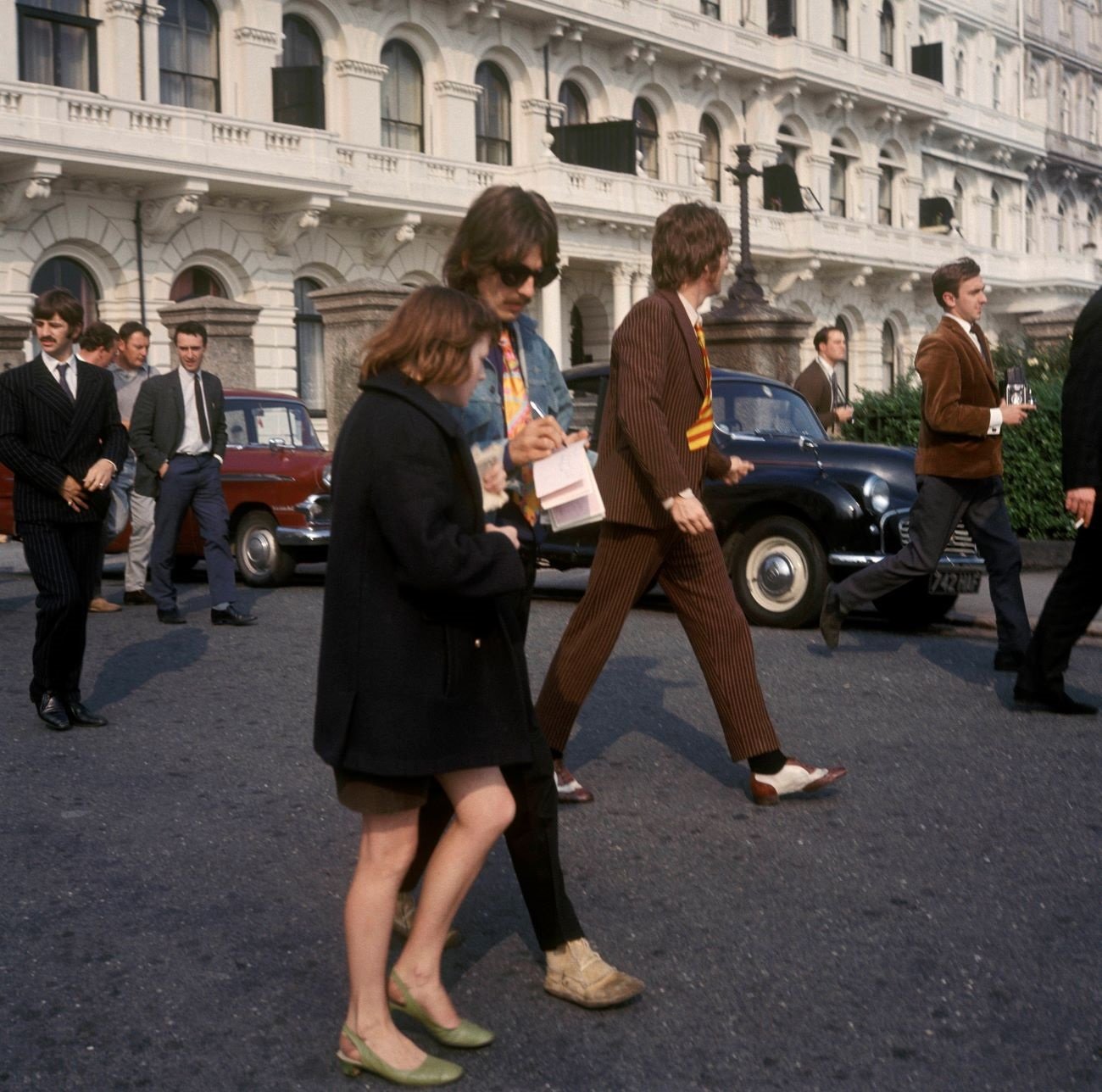 George Harrison signs his autograph for a fan.