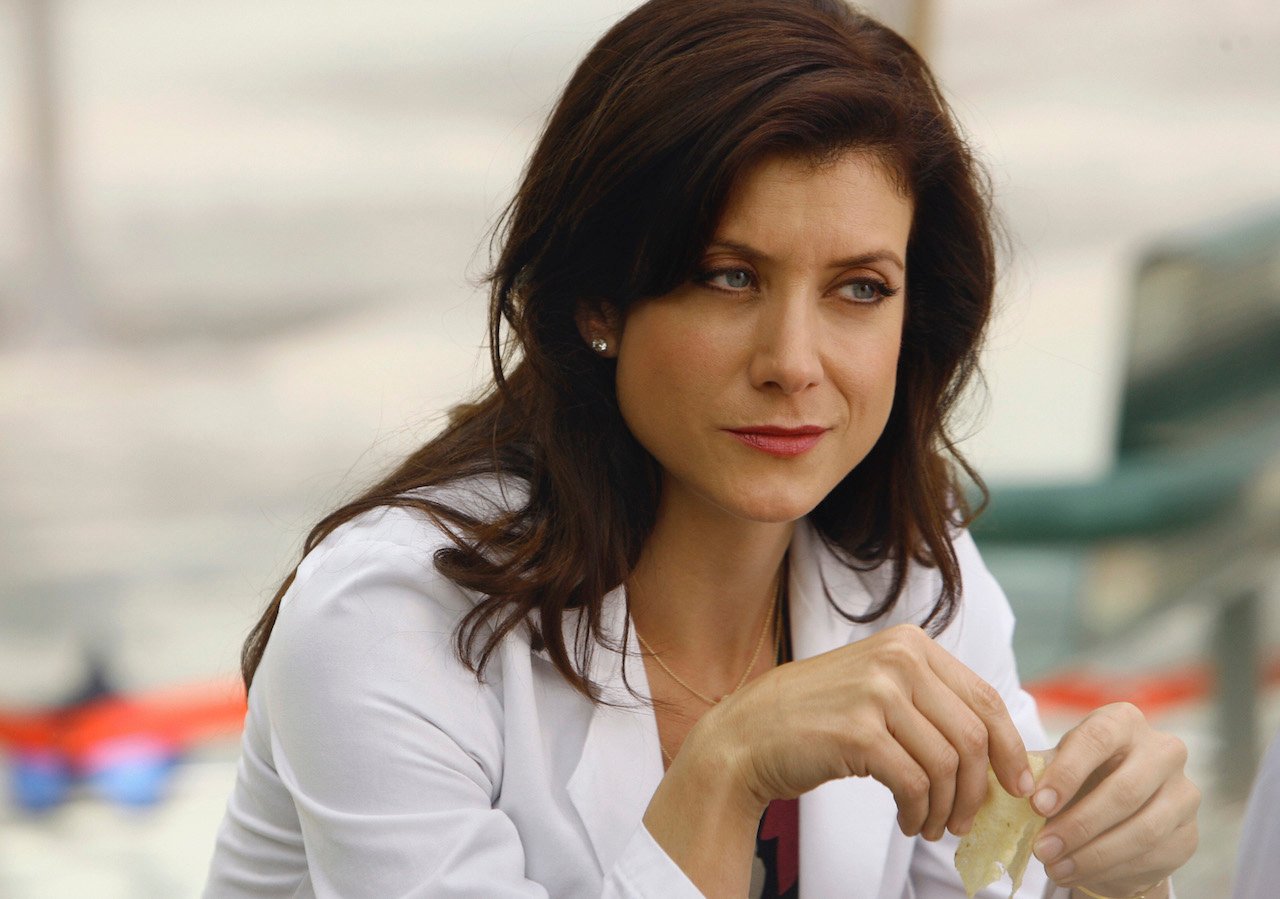 Kate Walsh sits wearing a medical coat on 'Grey's Anatomy'.