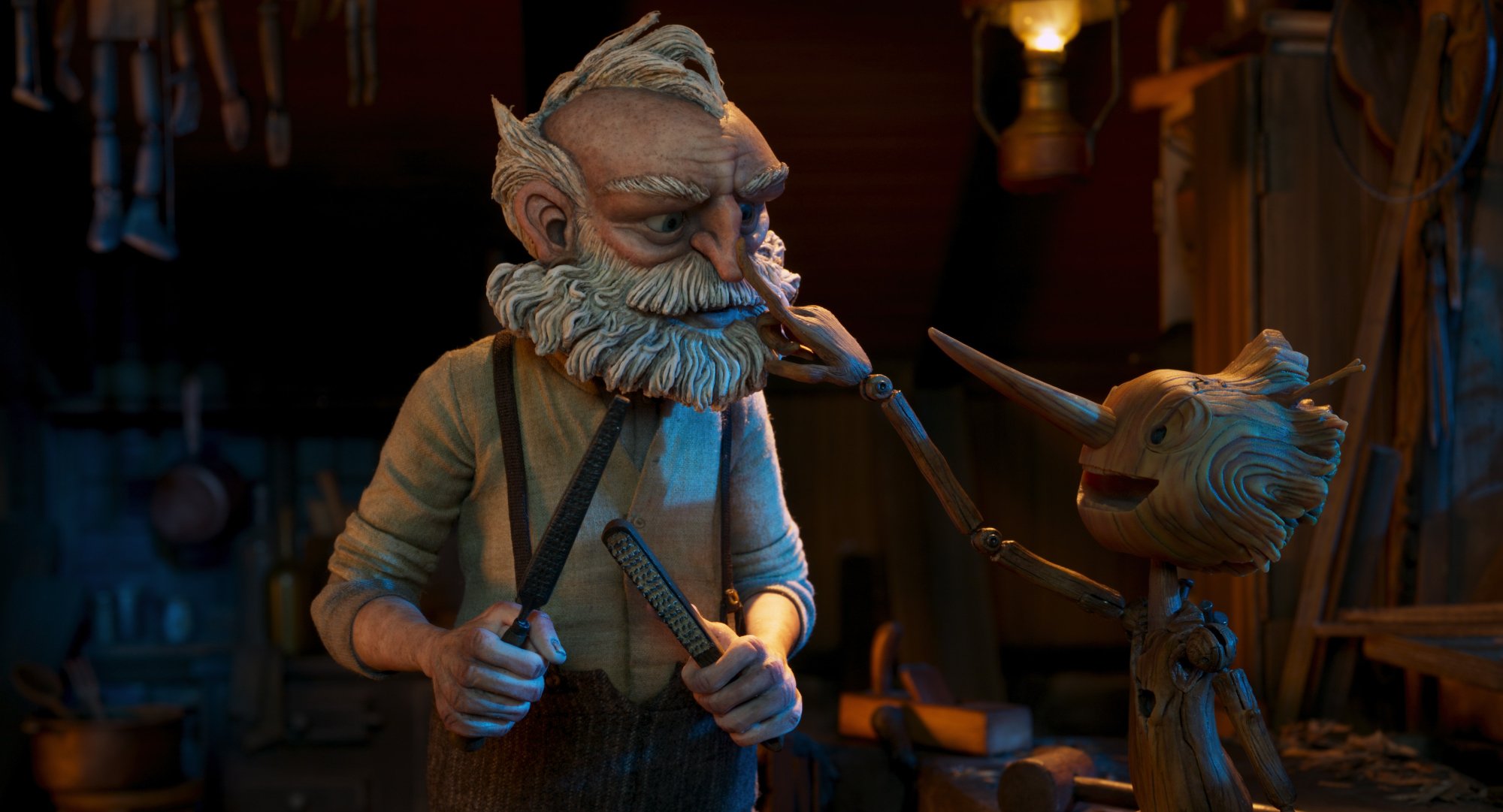 'Guillermo del Toro's Pinocchio' Geppetto (voiced by David Bradley) and Pinocchio (voiced by Gregory Mann). Pinocchio is reaching out, touching Geppetto's nose.