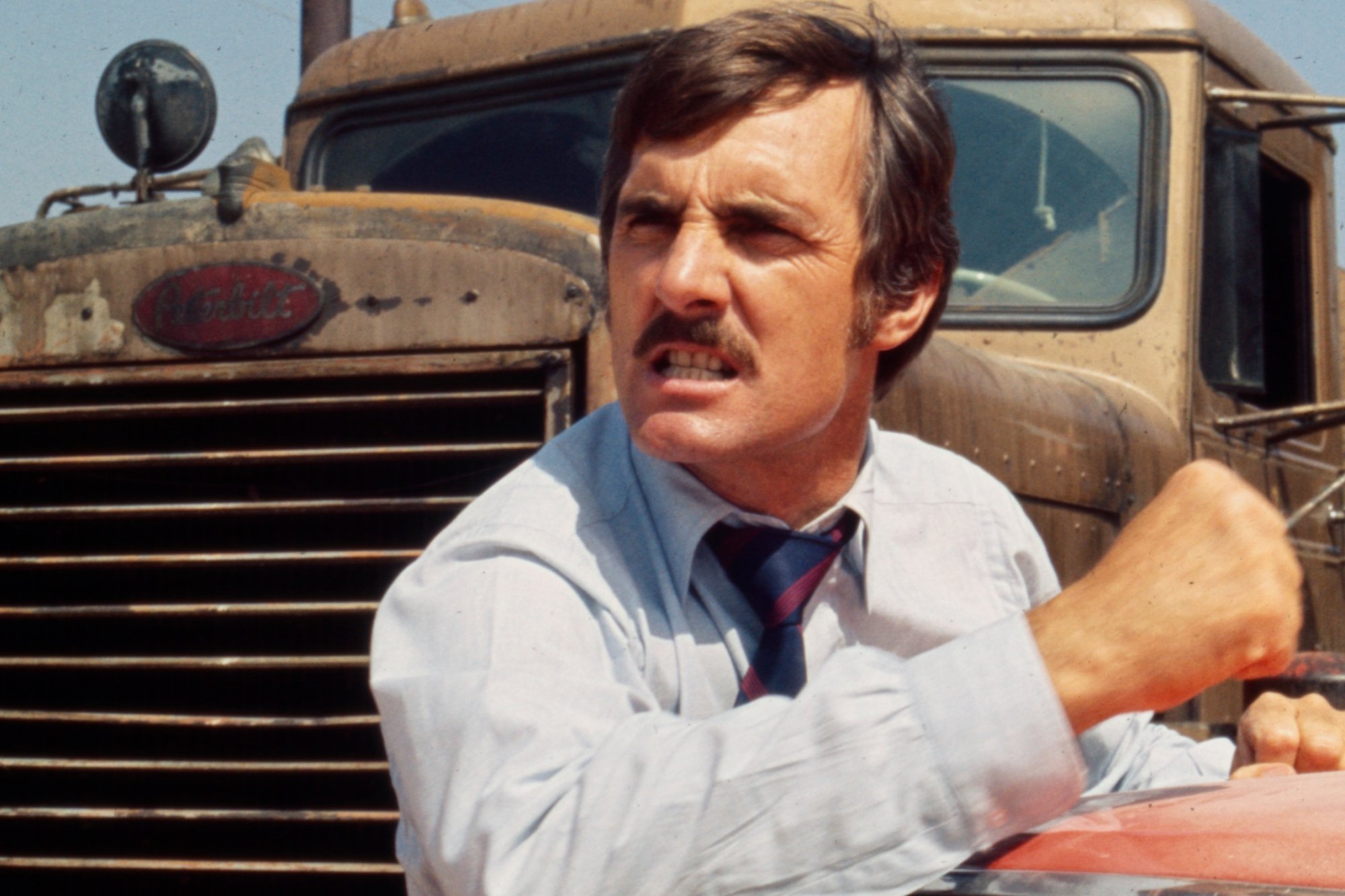 'Gunsmoke' actor Dennis Weaver in Steven Spielberg's 'Duel' clenching his fist in front of a semi-truck.