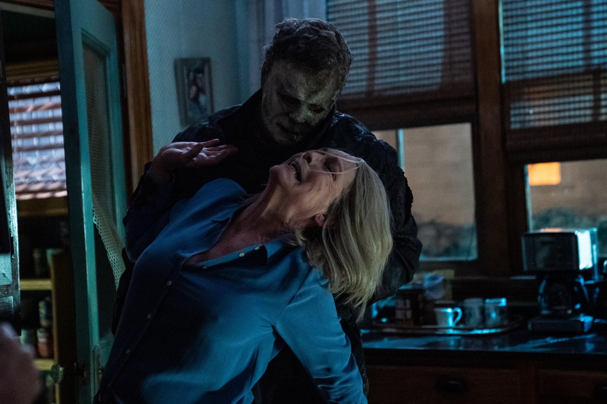 'Halloween Ends' Jamie Lee Curtis as Laurie Strode and James Jude Courtney The Shape/Michael Myers. Myers is twisting her arm back, as she's trying to fight back in the kitchen.