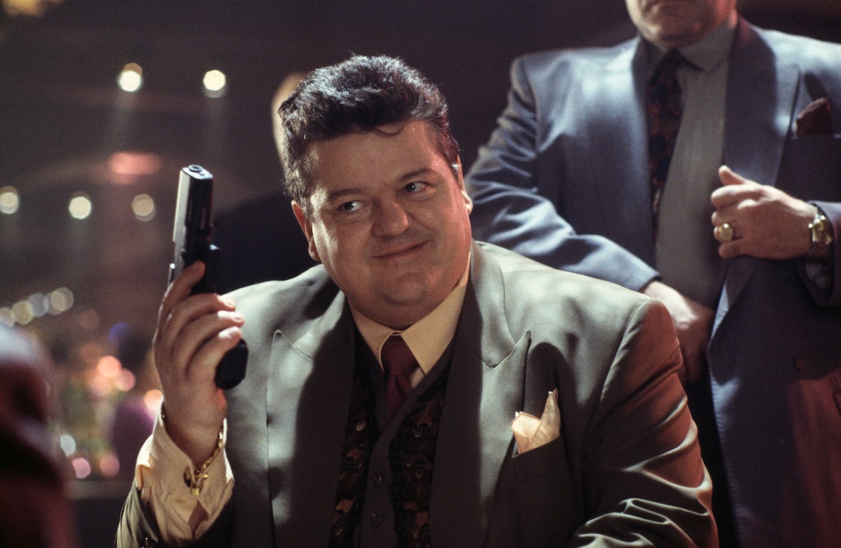 'Harry Potter' Hagrid star Robbie Coltrane holds a gun in 'Goldeneye'