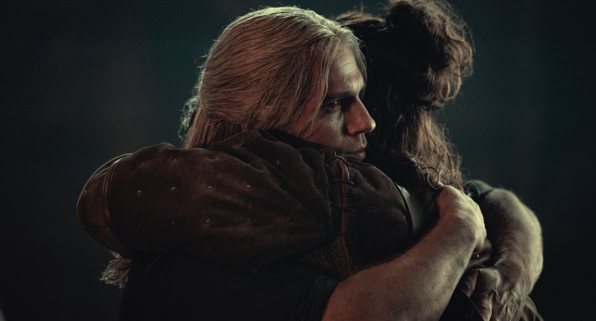 Henry Cavill as Geralt hugging Eskel in 'The Witcher' Season 2.