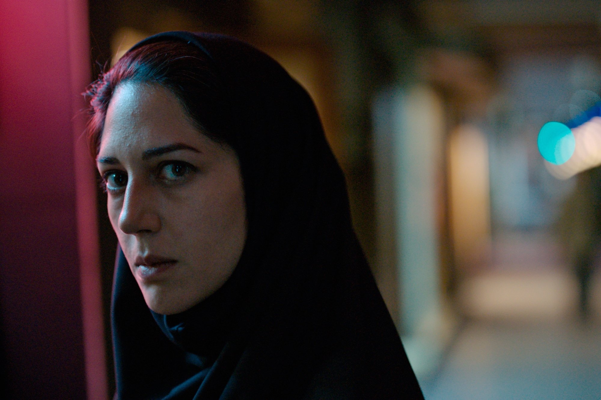 'Holy Spider' Zar Amir-Ebrahimi as Rahimi wearing a black chador looking intensely