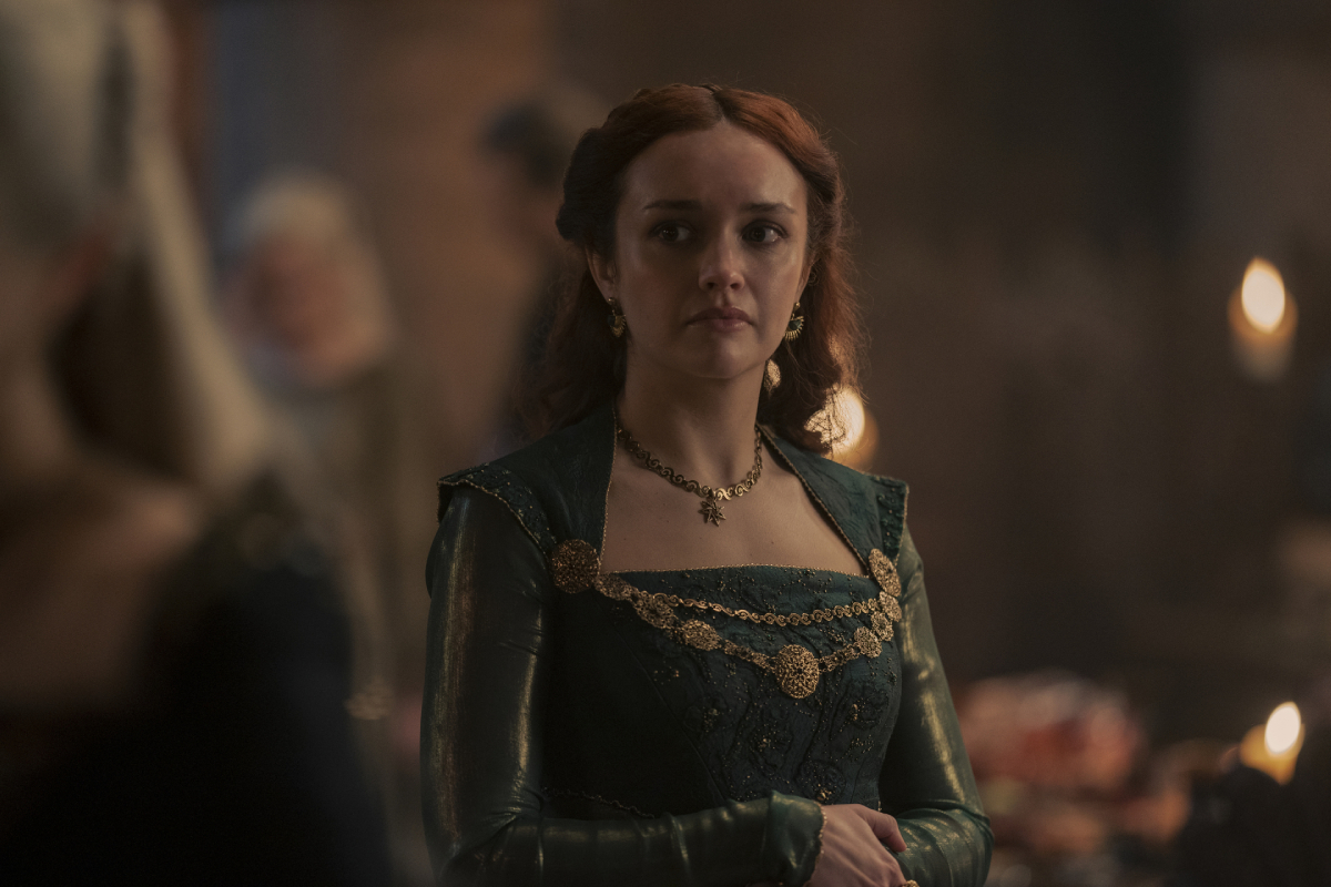 Olivia Cooke as Alicent Hightower in House of the Dragon. Alicent wears a green dress and gold jewelry.