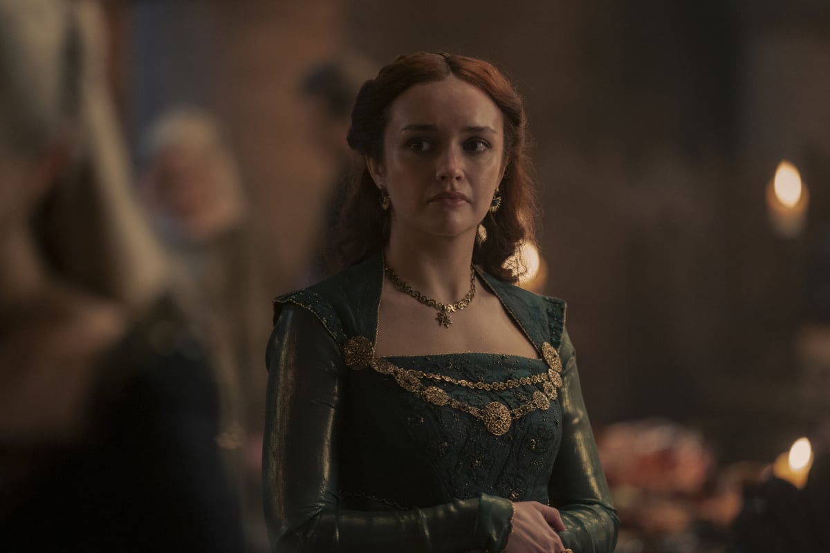 Olivia Cooke as Alicent Hightower in House of the Dragon. Alicent wears a green dress and gold jewelry.