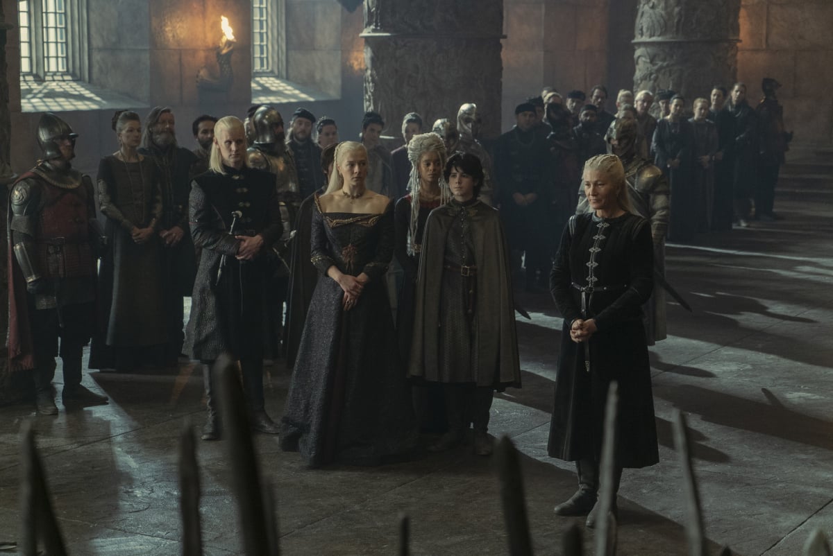Several characters in House of the Dragon Episode 8 stand in front of the Iron Throne.
