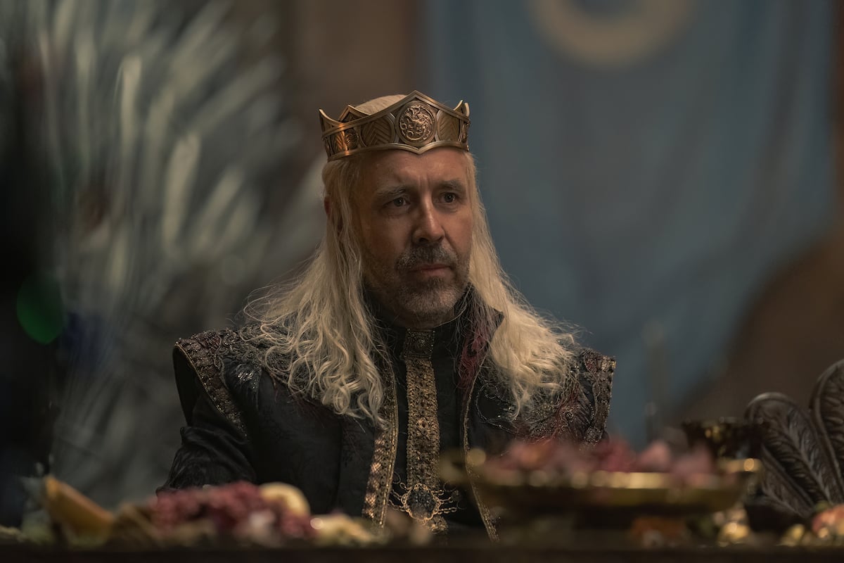 'House of the Dragon': King Viserys (Paddy Considine) sits at a dinner table wearing his crown