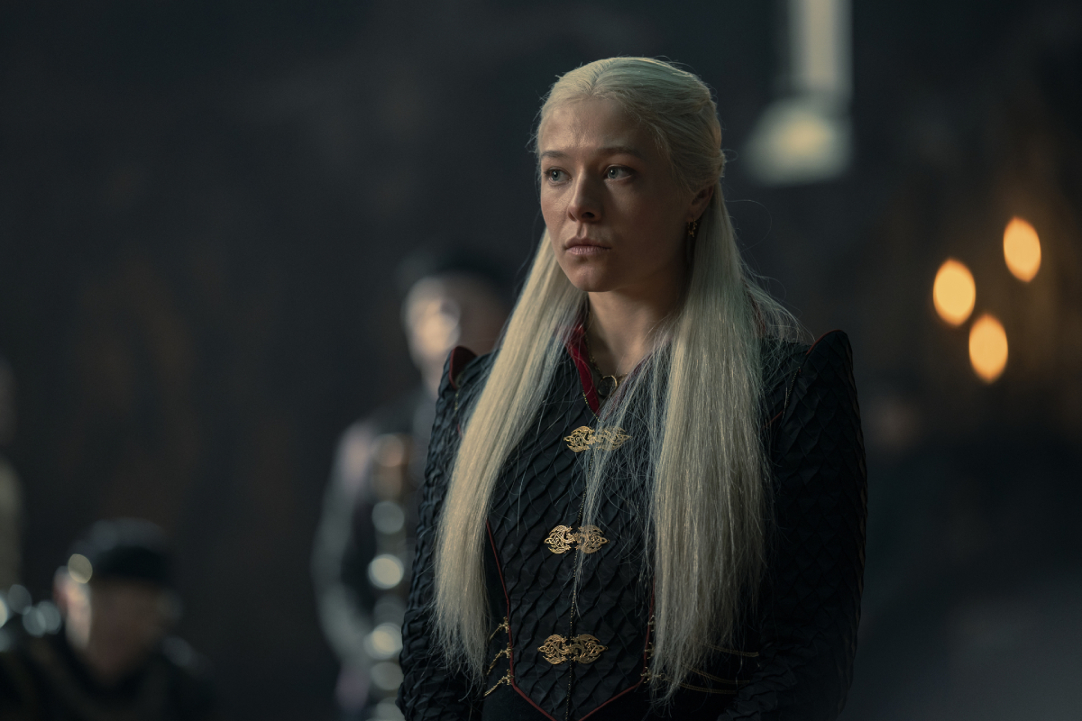 In the House of the Dragon finale, Rhaenyra stands at Dragonstone wearing a blue dress with gold clasps.