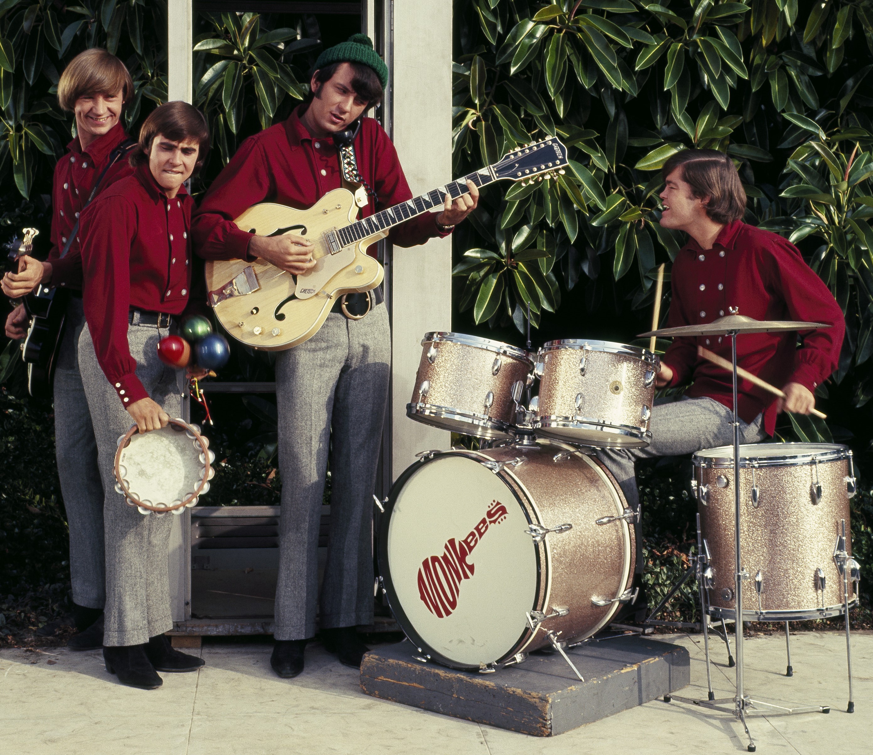 The Monkees’ Peter Tork, Davy Jones, Mike Nesmith, and Micky Dolenz wearing red