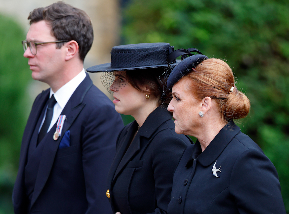 Sarah Ferguson, whose 'modest gesture' at Queen Elizabeth's funeral was, according to body language expert Judi James, refusing to walk ahead of her daughters Princess Beatrice and Princess Eugenie, walks with Princess Eugenie and Jack Brooksbank outside St. George's Chapel