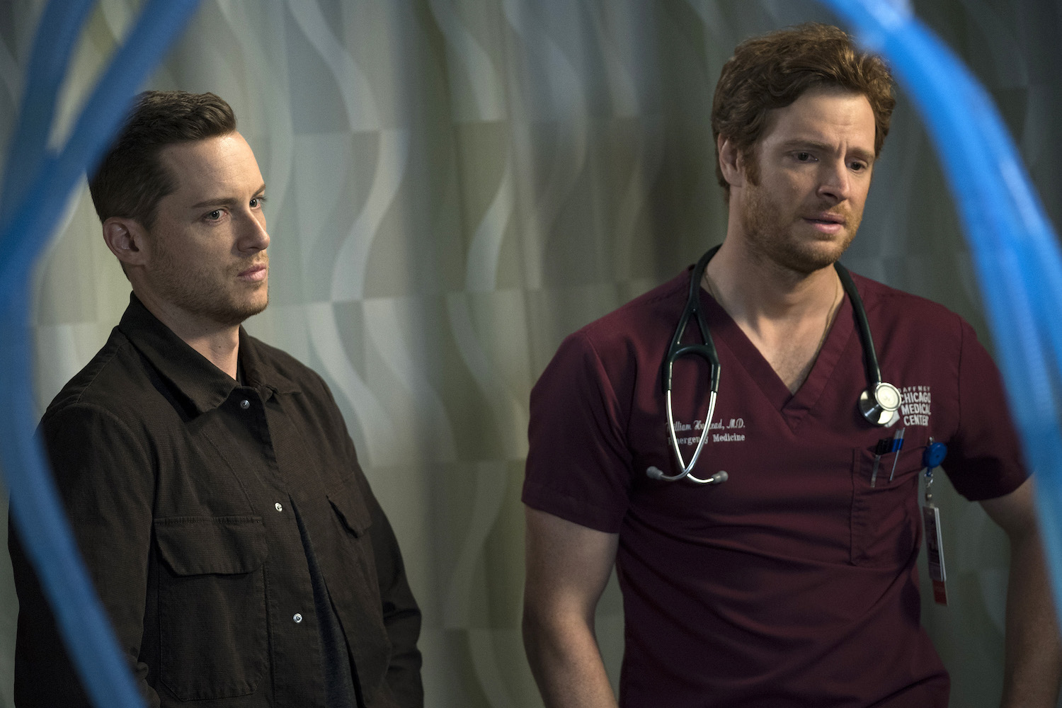 Jesse Lee Soffer as Jay Halstead from 'Chicago P.D.' Season 10 standing next to Nick Gehlfuss as Will Halstead in 'Chicago Med'