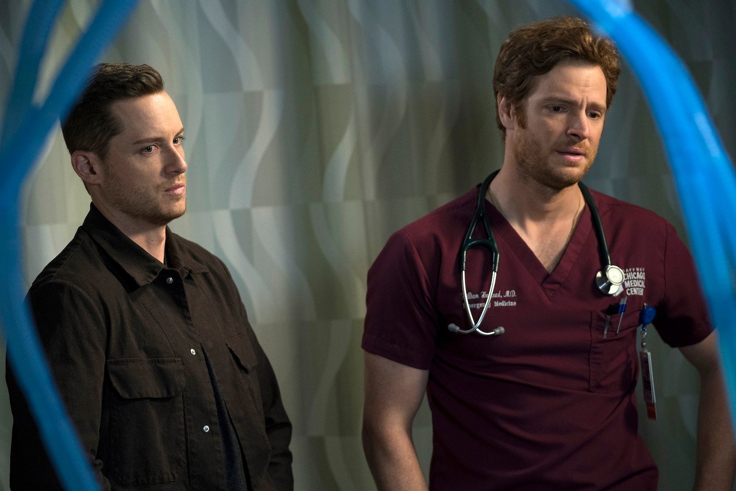 Jesse Lee Soffer as Jay Halstead from 'Chicago P.D.' Season 10 standing next to Nick Gehlfuss as Will Halstead in 'Chicago Med'