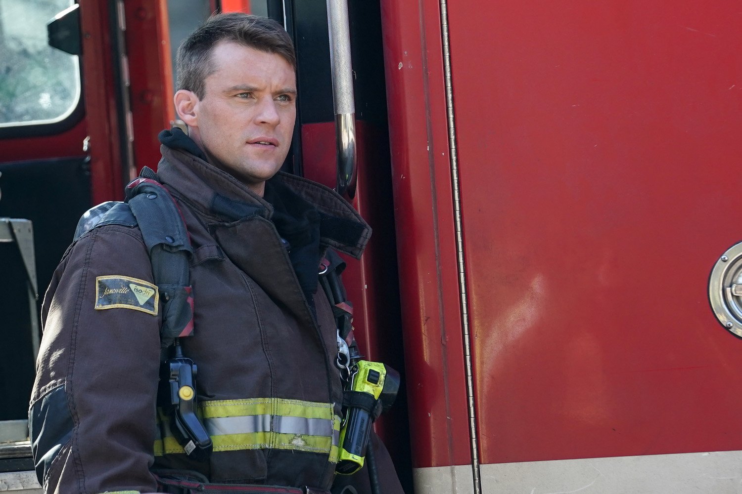 Jesse Spencer as Matt Casey in 'Chicago Fire.' He's wearing a firefighting uniform next to a truck