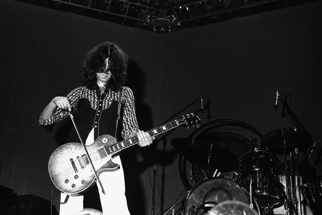 Jimmy Page bows his guitar during a 1975 concert. He first bowed his guitar on a 1967 movie soundtrack.