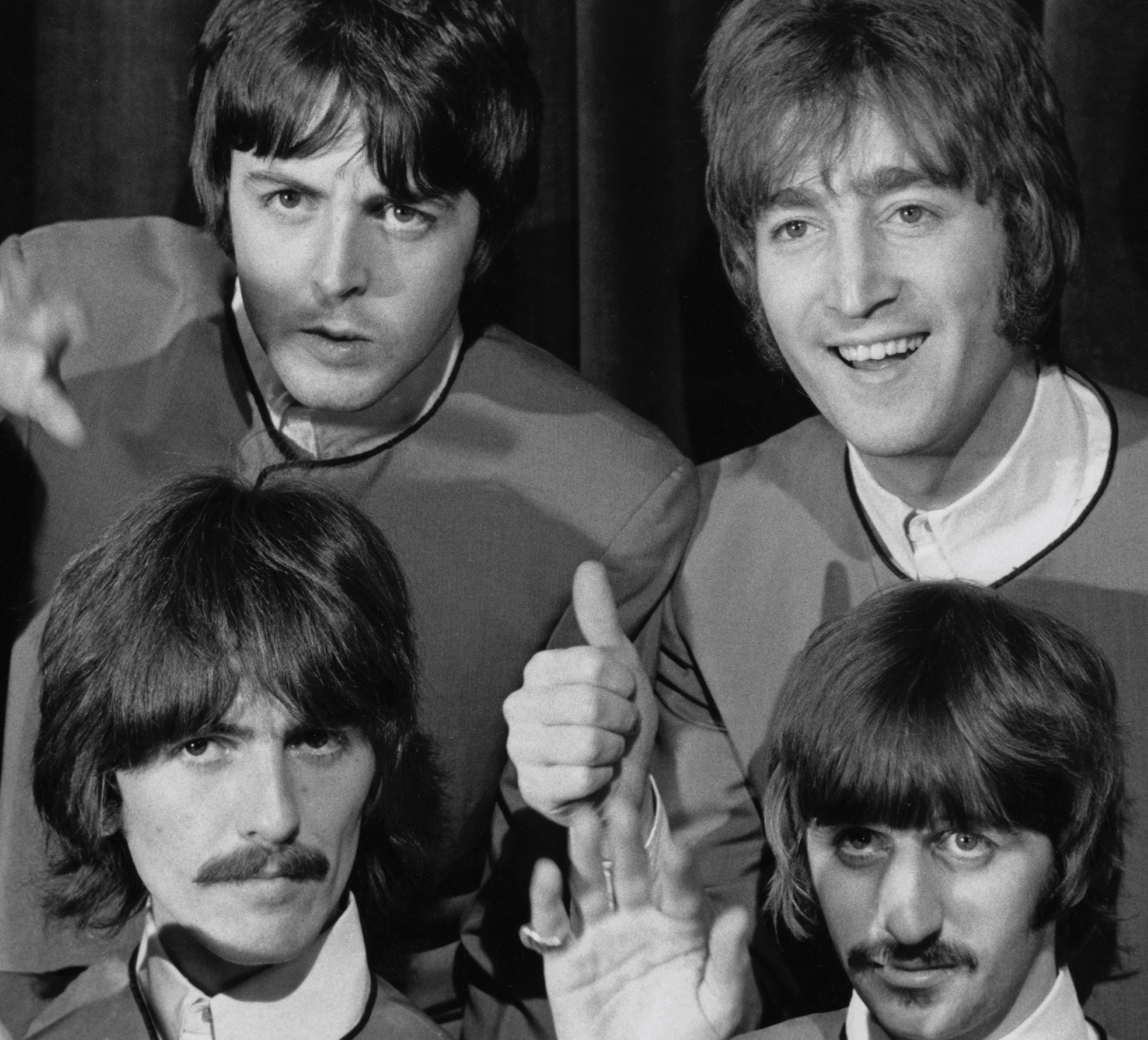 The Beatles in front of a curtain during the "Hello, Goodbye" era