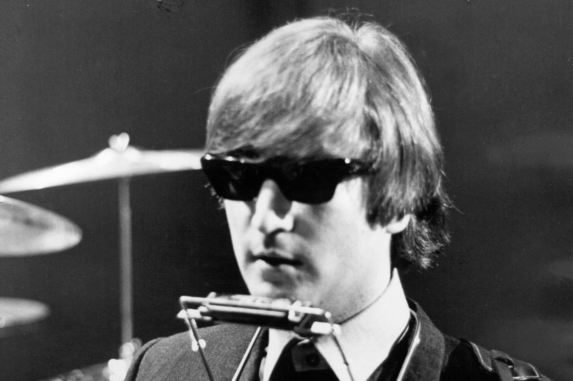 John Lennon playing harmonica