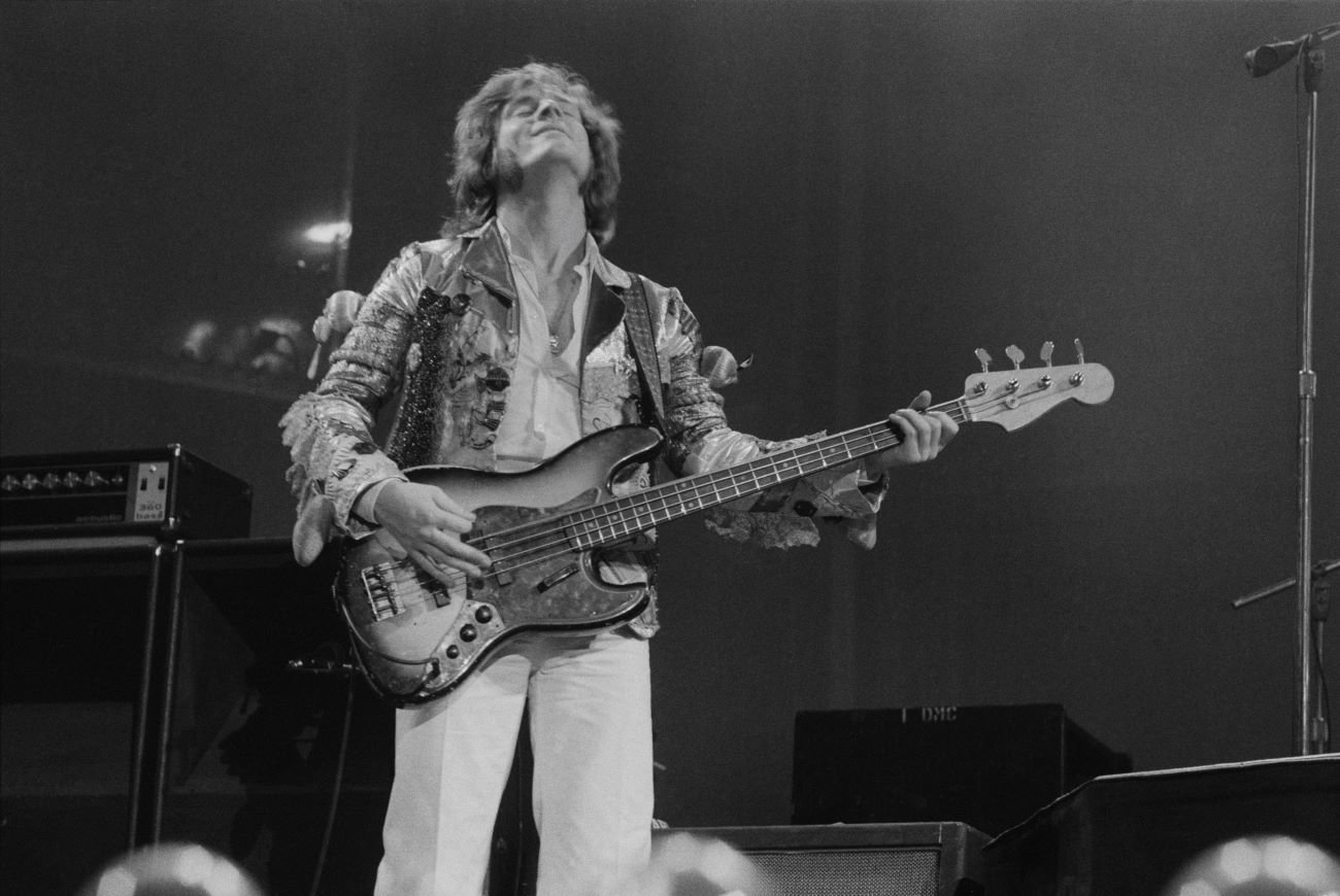 A black and white picture of John Paul Jones playing guitar.