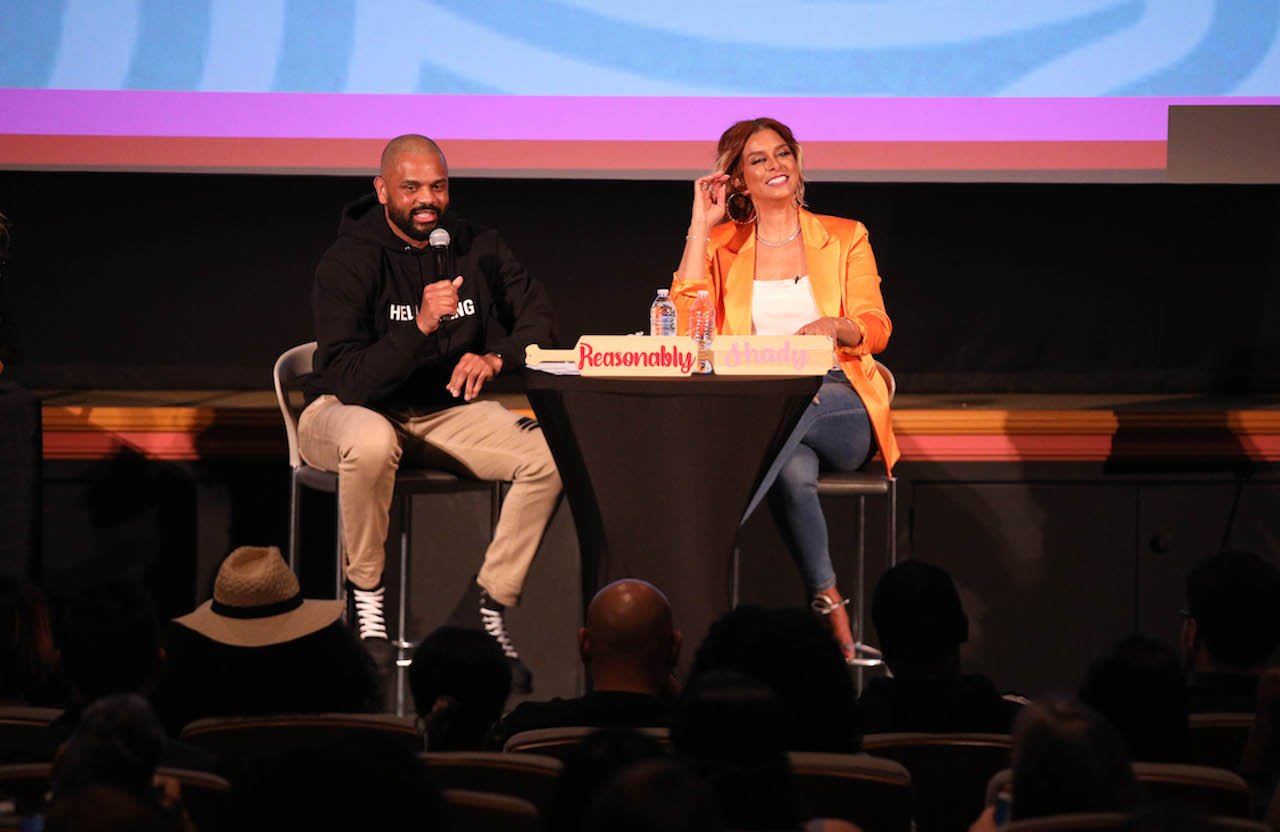 Juan and Robyn Dixon on stage smiling together; Robyn says they wouldn't have reconciled if it weren't for them being broke and cast on the show