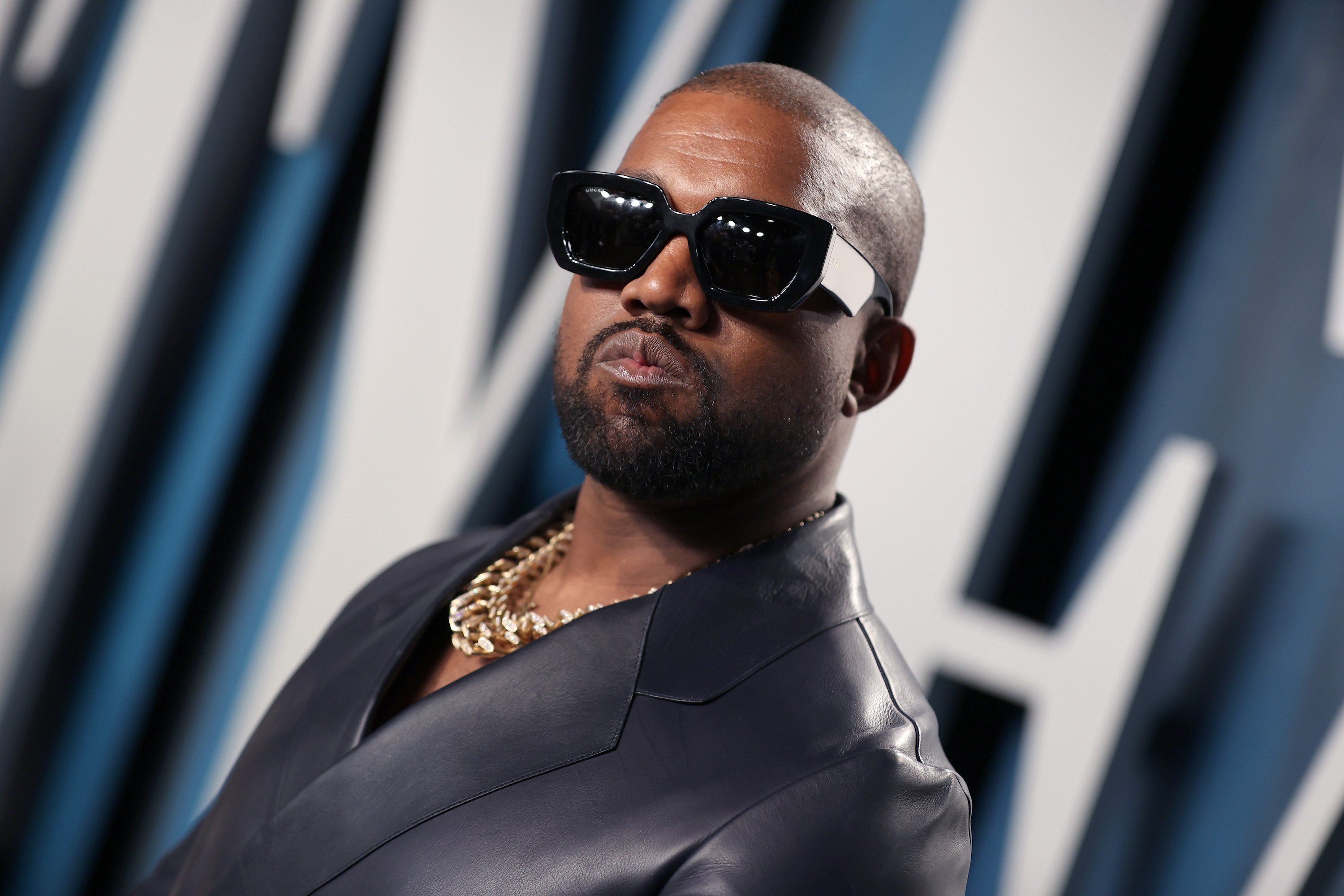 Kanye West, who was called out by longtime collaborator Mike Dean, wearing sunglasses and a black leather jacket
