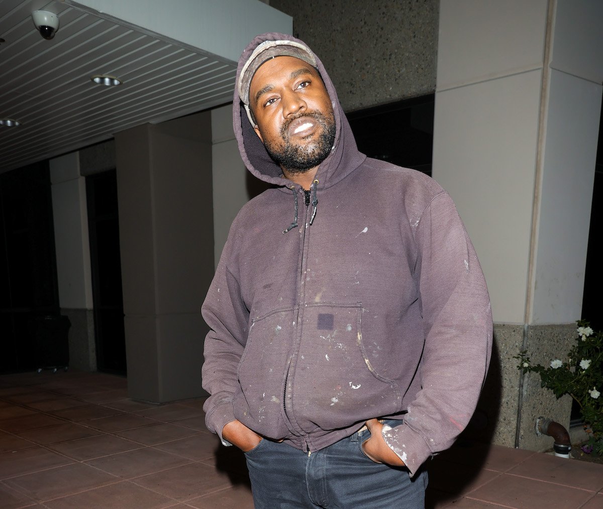 antisemite Kanye West aka Ye in a purple hoodie