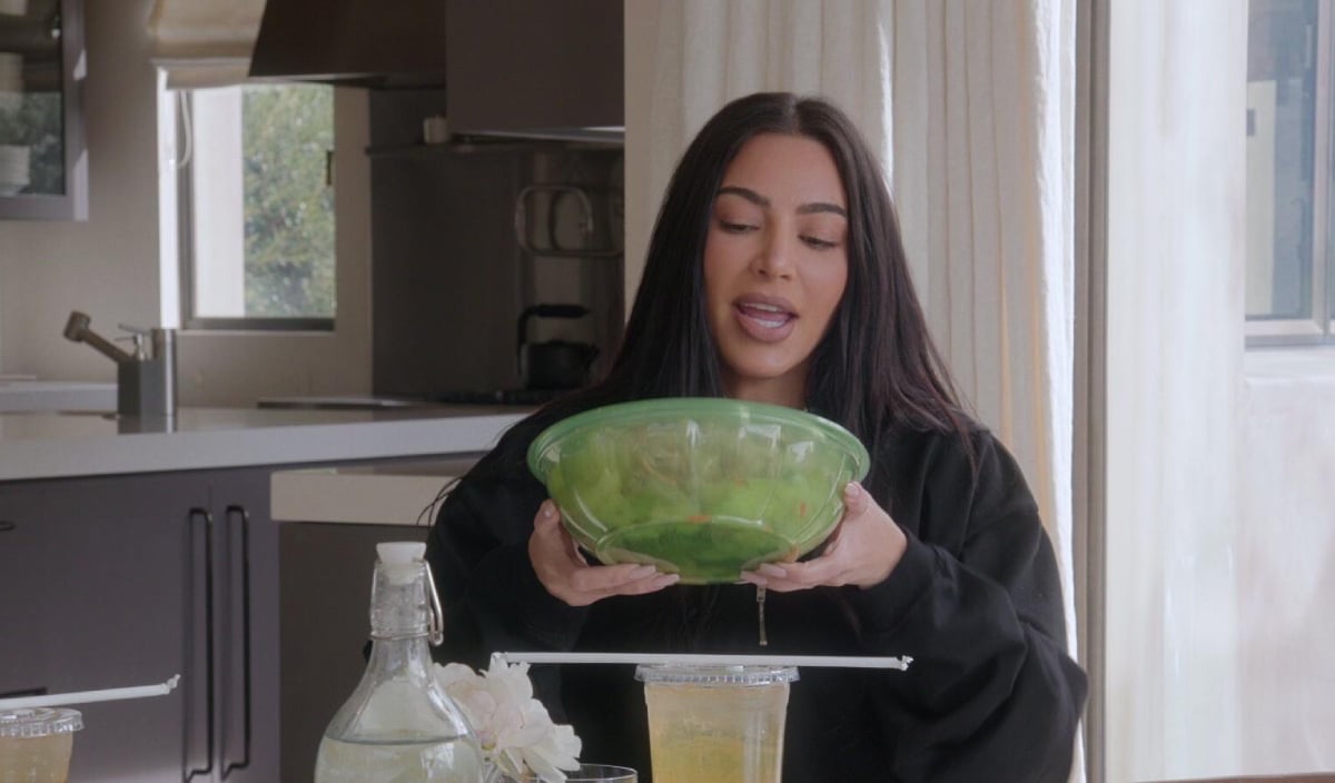Kim Kardashian shakes her Health Nut salad in an image from The Kardashians
