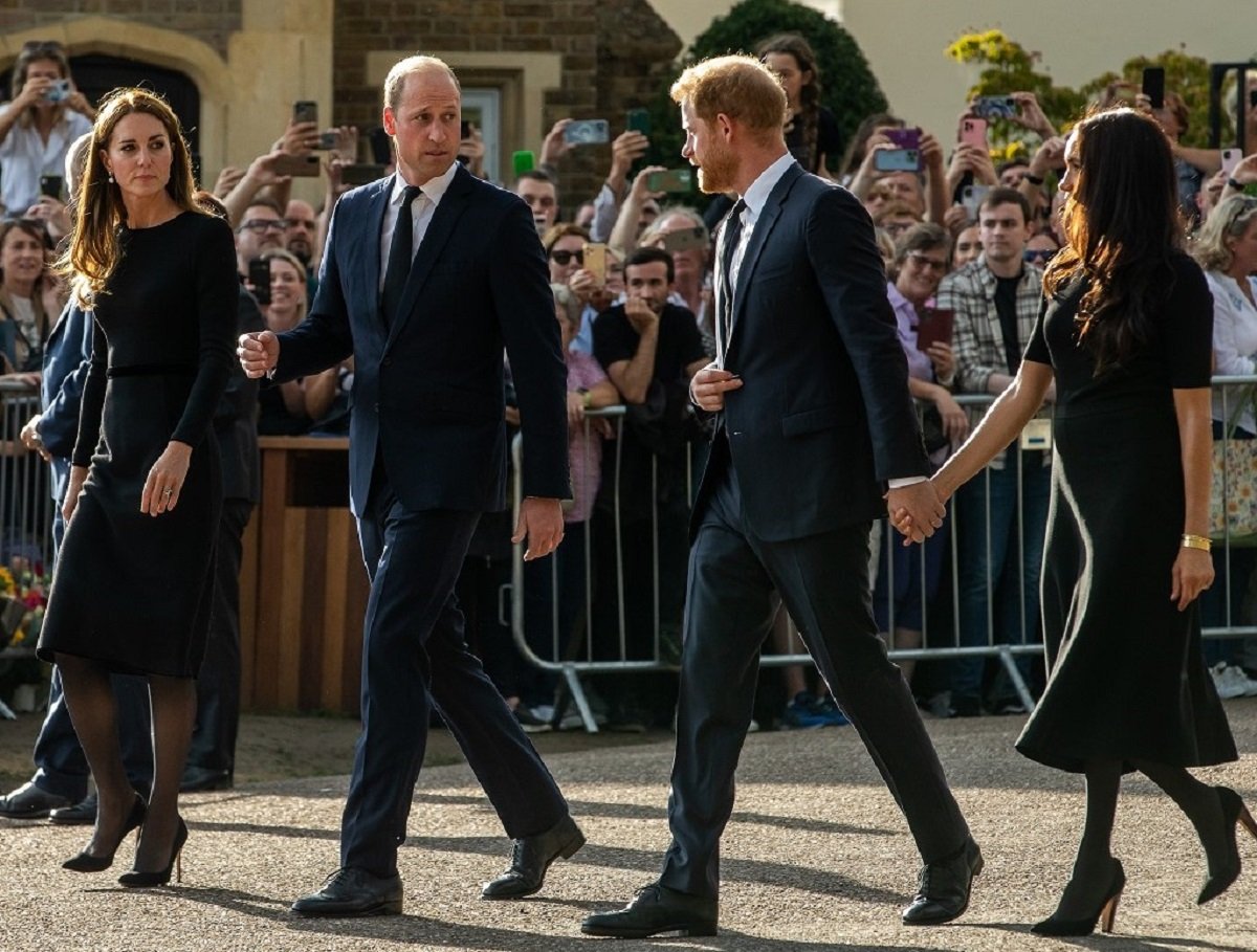 Kate Middleton, Prince William, Prince Harry, and Meghan Markle proceed to greet well-wishers outside Windsor Castle