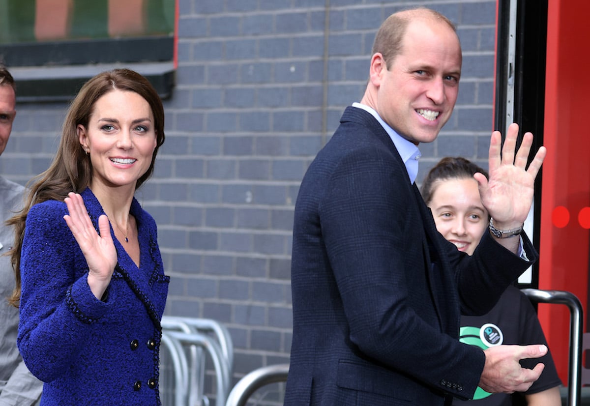 Kate Middleton and Prince William, who appeared to launch a 'new era of PDAs' as the Prince and Princess of Wales, according to Judi James, wave outside Coach Core event on Oct. 13, 2022