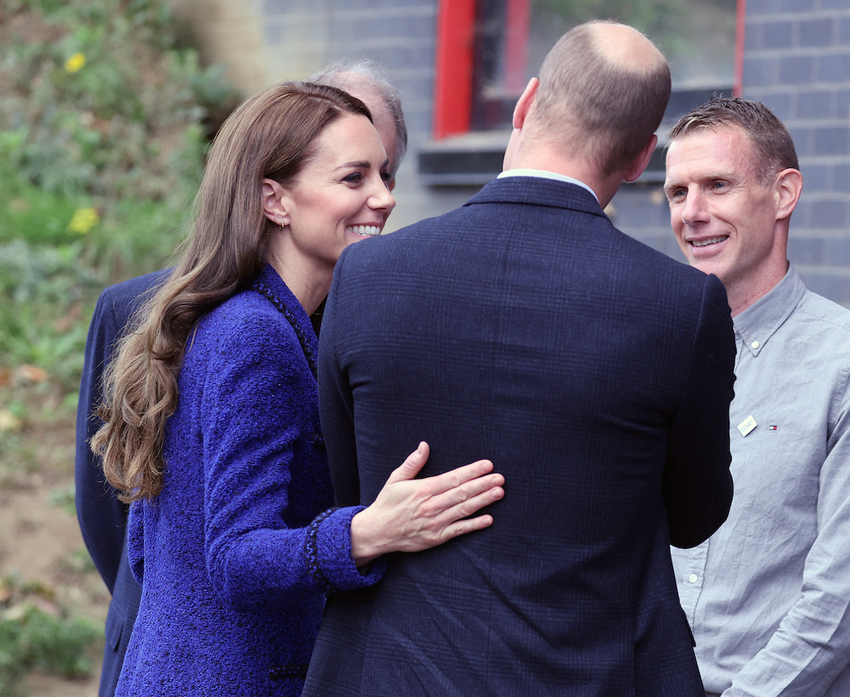 Kate Middleton and Prince William, who launched a 'new era of PDAs' at Coach Core event on Oct. 13, 2022, according to body language expert Judi James, engage in a public display of affection on Oct. 13, 2022