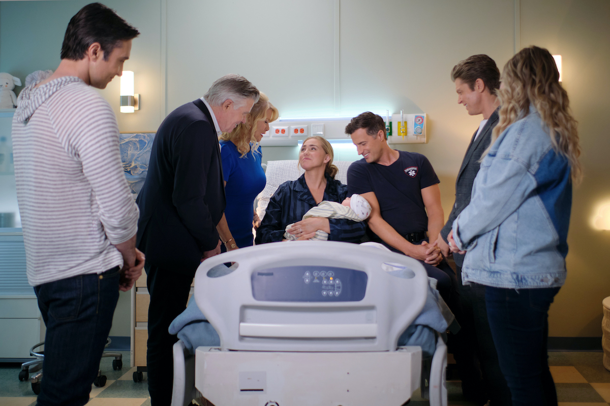 Sarah holding her new baby in hospital bed surrounded by family in 'Chesapeake Shores' Season 6 Episode 10