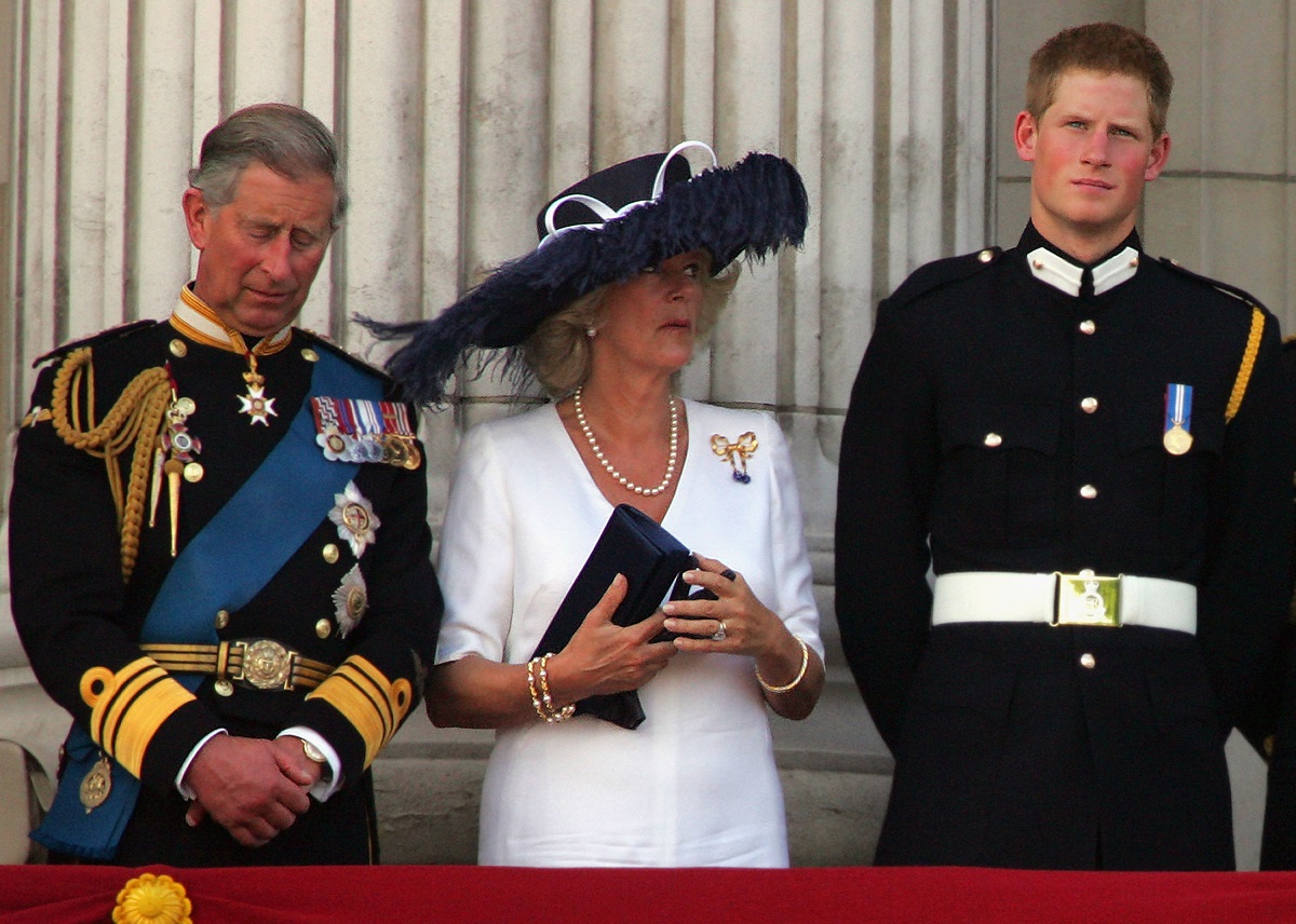 King Charles III, Camilla Parker Bowles, and Prince Harry watching a flypast from the Buckingham Palace balcony