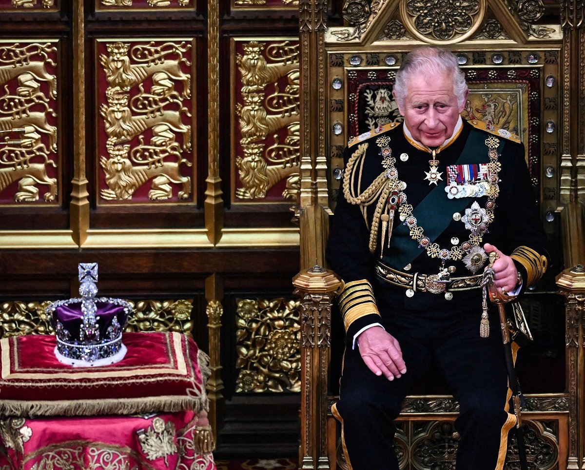 King Charles III's, who will have his coronation next year, sitting by the Imperial State Crown during the State Opening of Parliament