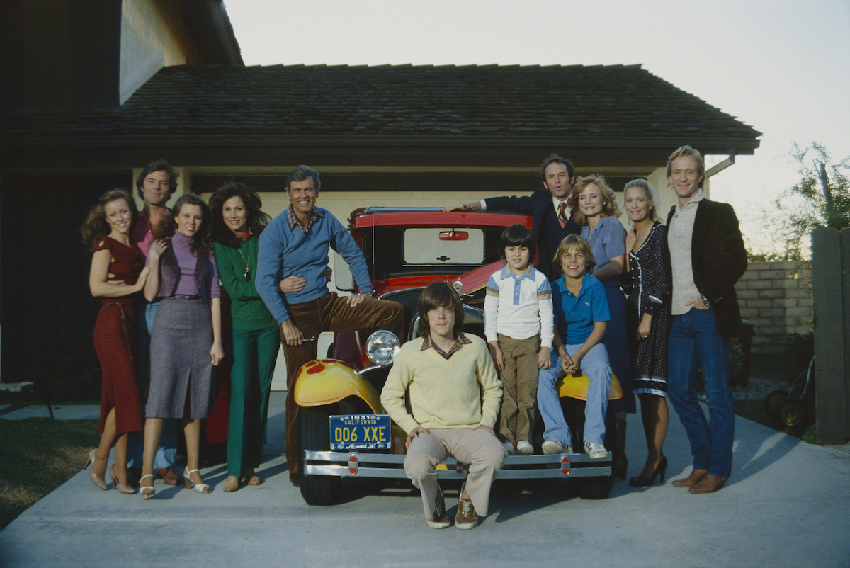 The cast of 'Knots Landing' standing in front of a house