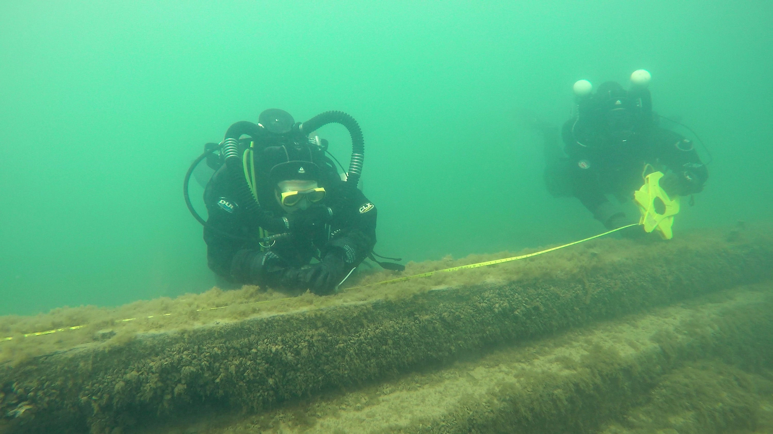 Divers examine a shipwreck in Lake Michigan