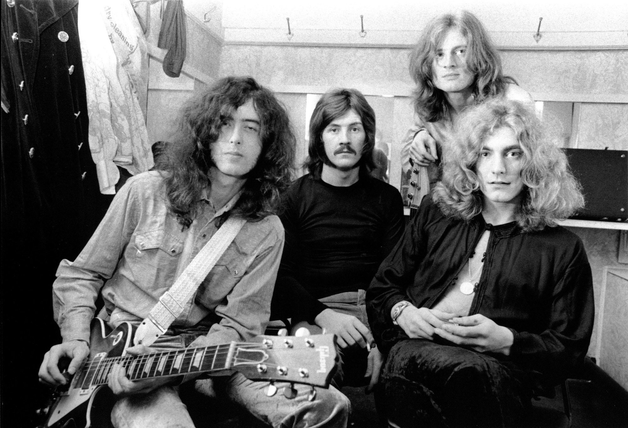 A black-and-white photo of Jimmy Page, John Bonham, John Paul Jones, and Robert Plant of Led Zeppelin