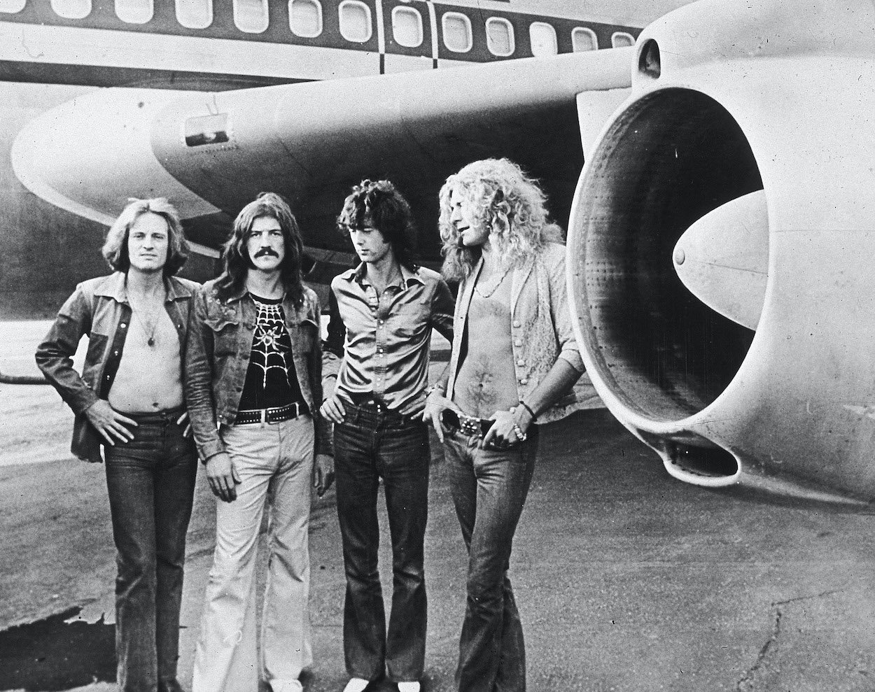 John Paul Jones (from left), John Bonham, Jimmy Page, and Robert Plant stand next to Led Zeppelin's airplane dubbed The Starship, which they didn't own.