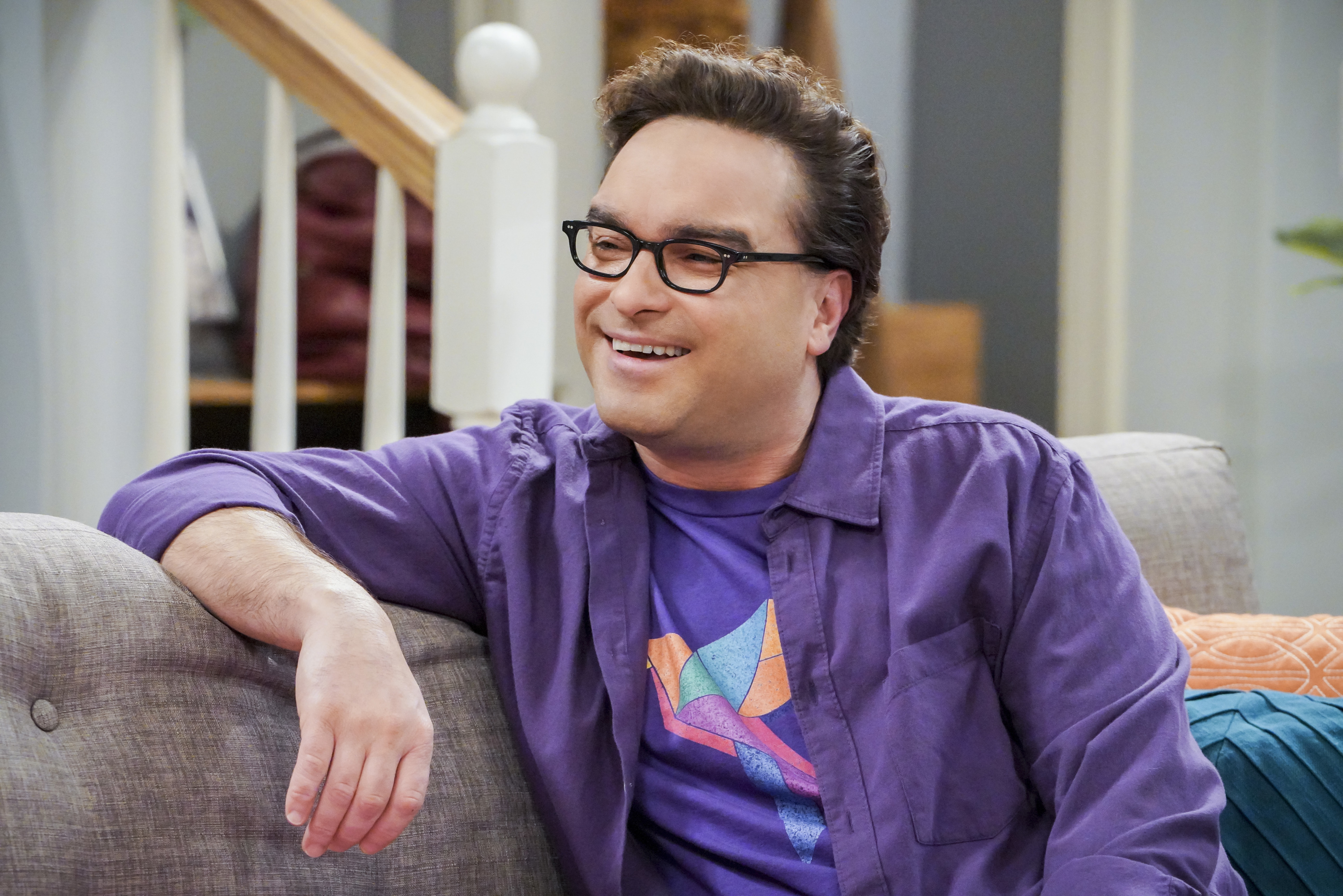 Leonard Hofstadter sits on the couch in an episode of 'The Big Bang Theory'