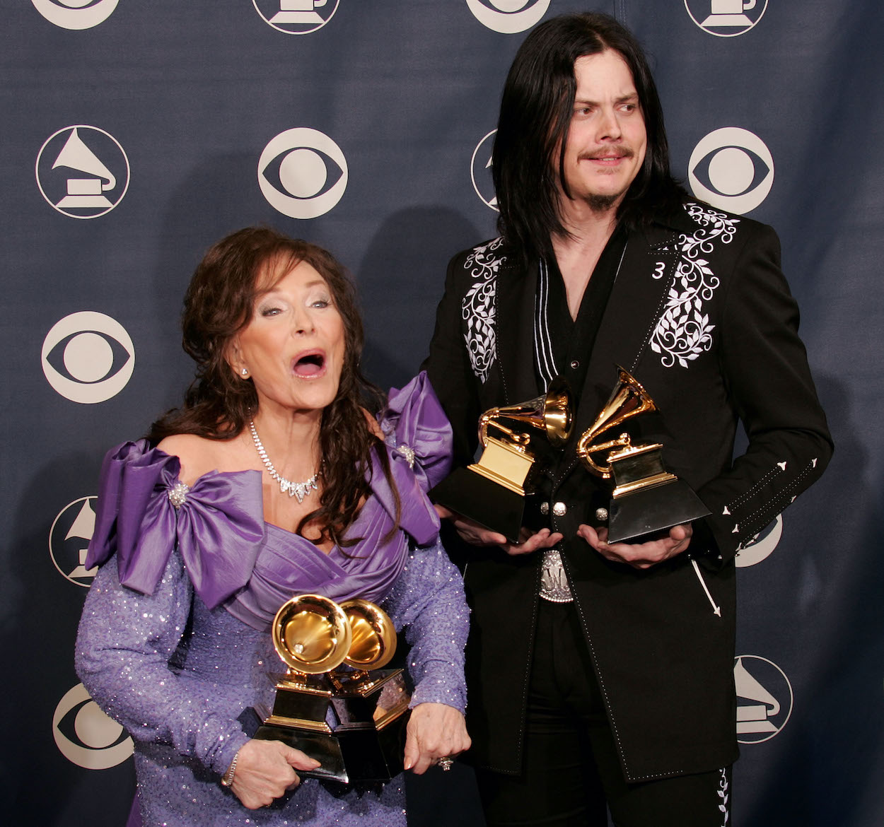 Loretta Lynn (left) hold the two Grammy Awards she won in 2005 while working alongside Jack White (right).