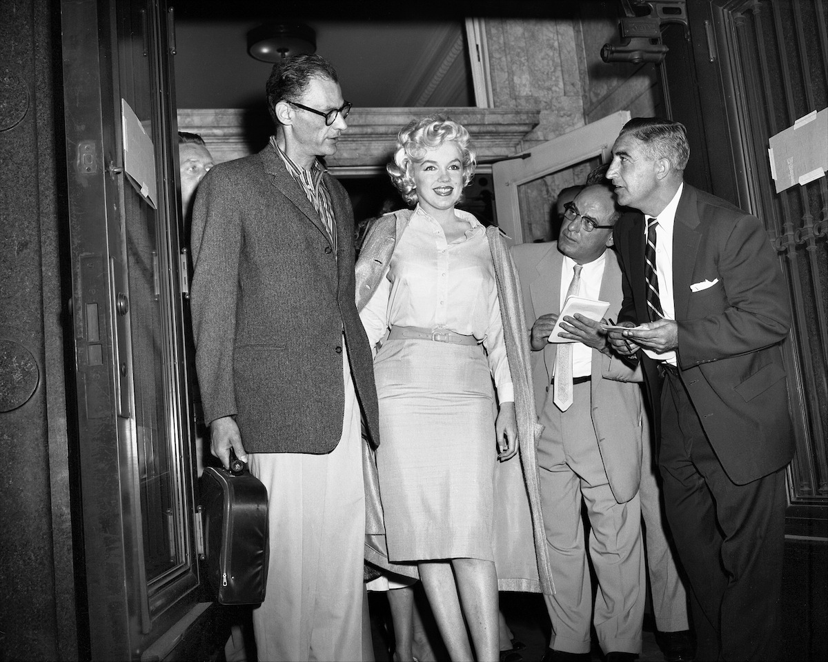 Playwright Arthur Miller and wife Marilyn Monroe greet the media