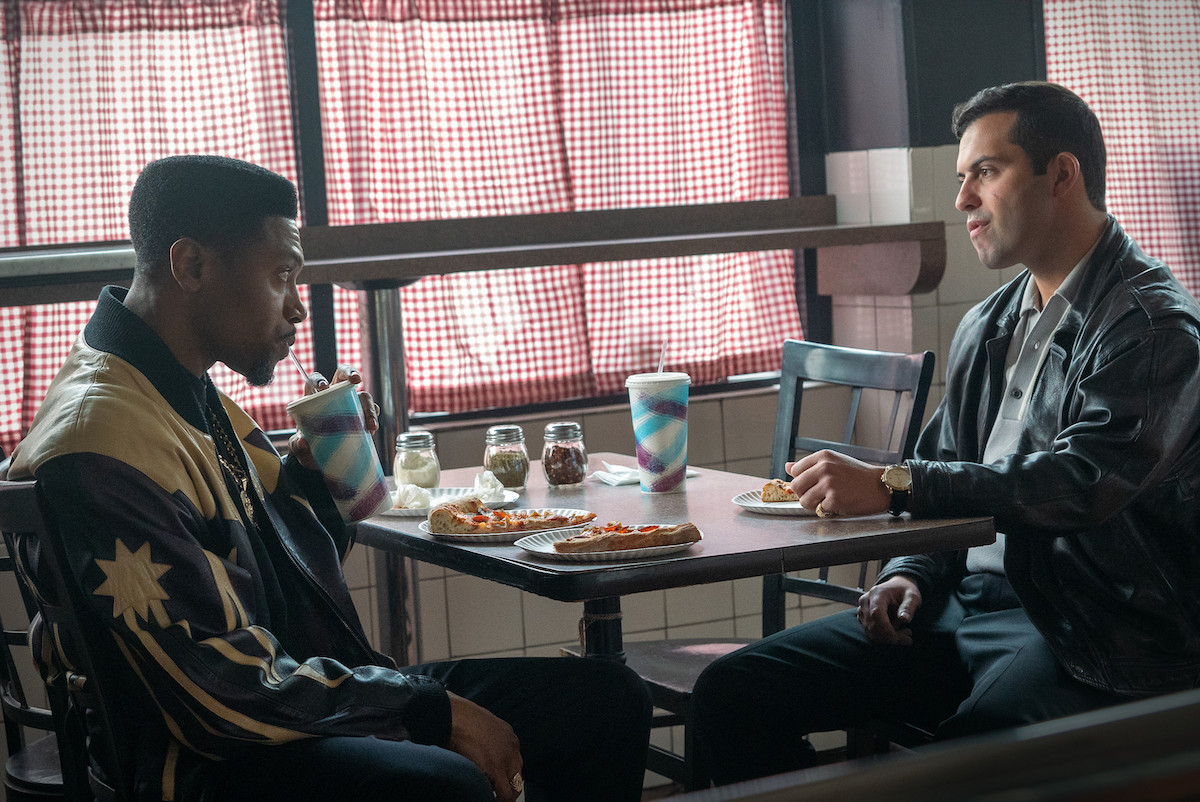 London Brown as Marvin Thomas and David Castro as Marco Boselli chatting over a slice of pizza in 'Power Book III: Raising Kanan'