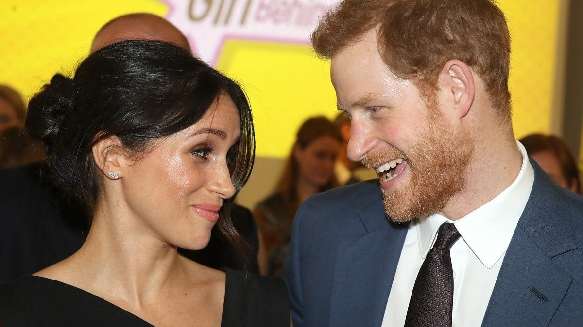 Meghan Markle and Prince Harry, who an expert claims "morphs" into all his dating partners, smiling at one another during a Women's Empowerment reception